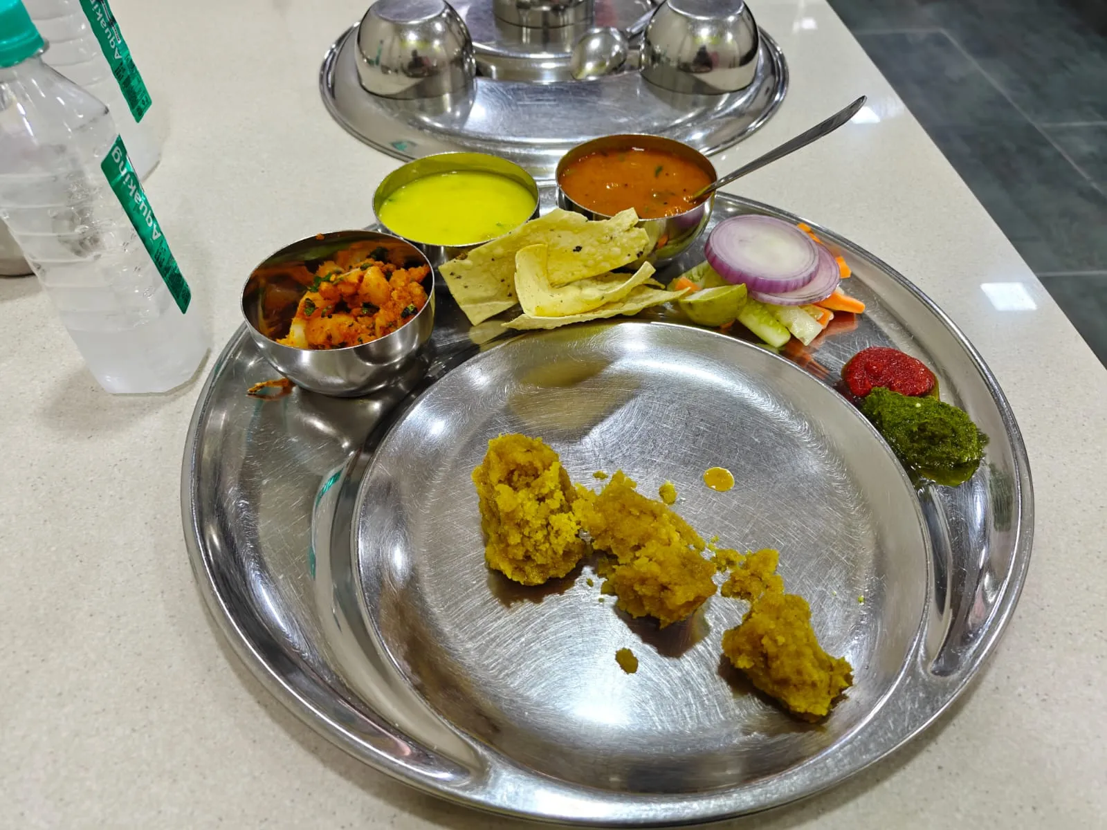 Dal bafle thali with aloo sabji, kadhi, dal, papad and chutneys at Rajhans Dal Bafle